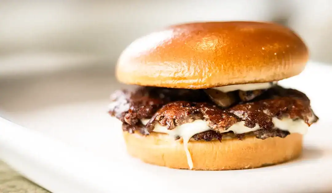 A smash burger with caramelised crust and melted cheese at The Fat Bull Co. Nicosia burger shop on a summer afternoon